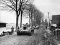 Колонна советских самоходных орудий СУ-76 в населённом пункте на подступах к Кёнигсбергу. Март–апрель 1945