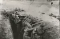 Григорий Фрид. Стрелки ведут огонь из окопа в противогазах. 1916