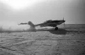 Советские двухместные штурмовики Ил-2 взлетают с полевого аэродрома. 1942