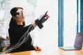 Женщина в головном дисплее и управляющих перчатках виртуальной реальности