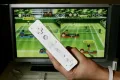 Игровая консоль Nintendo Wii, подключённая к телевизору, и контроллер Wii Remote